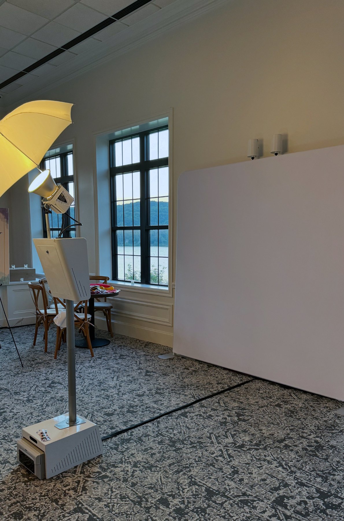 The booth built against a white backdrop in a smaller room