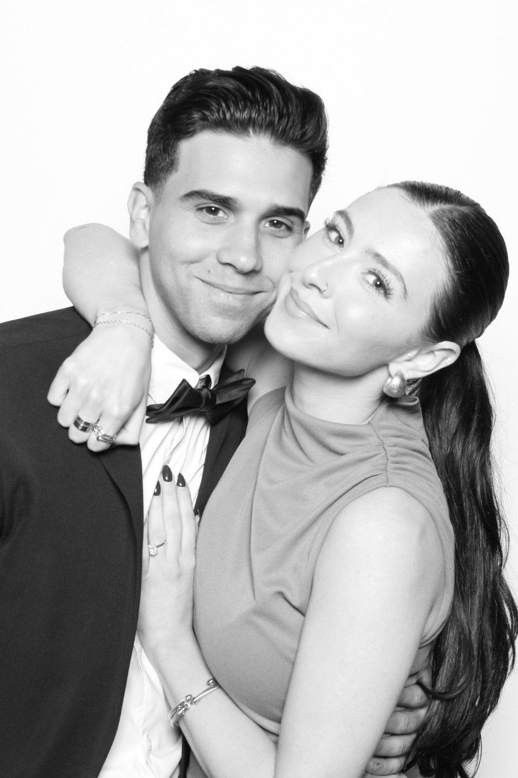 A couple photographed in black and white under the glam booth lighting