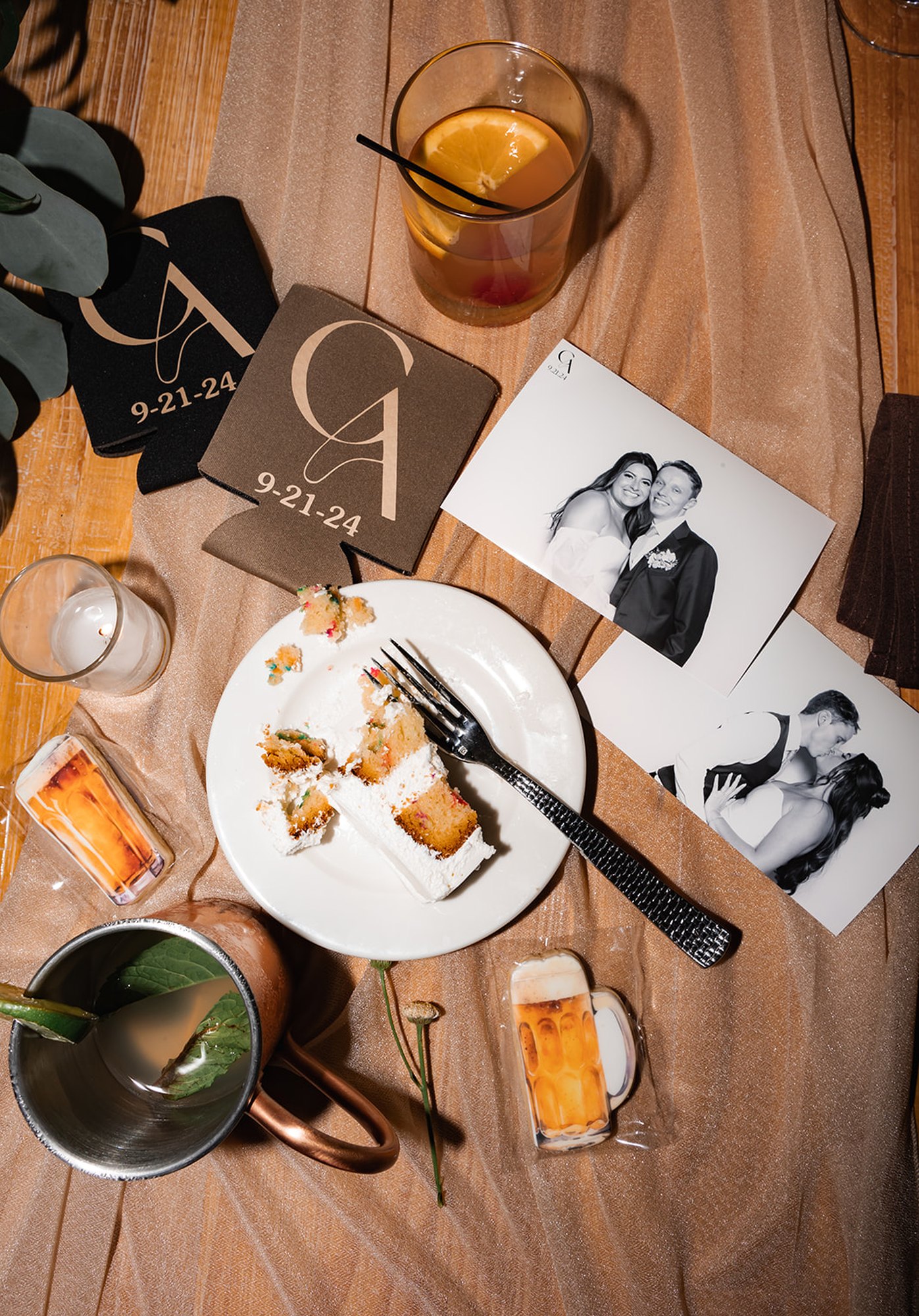 Printed photos from the booth laid out on a reception table