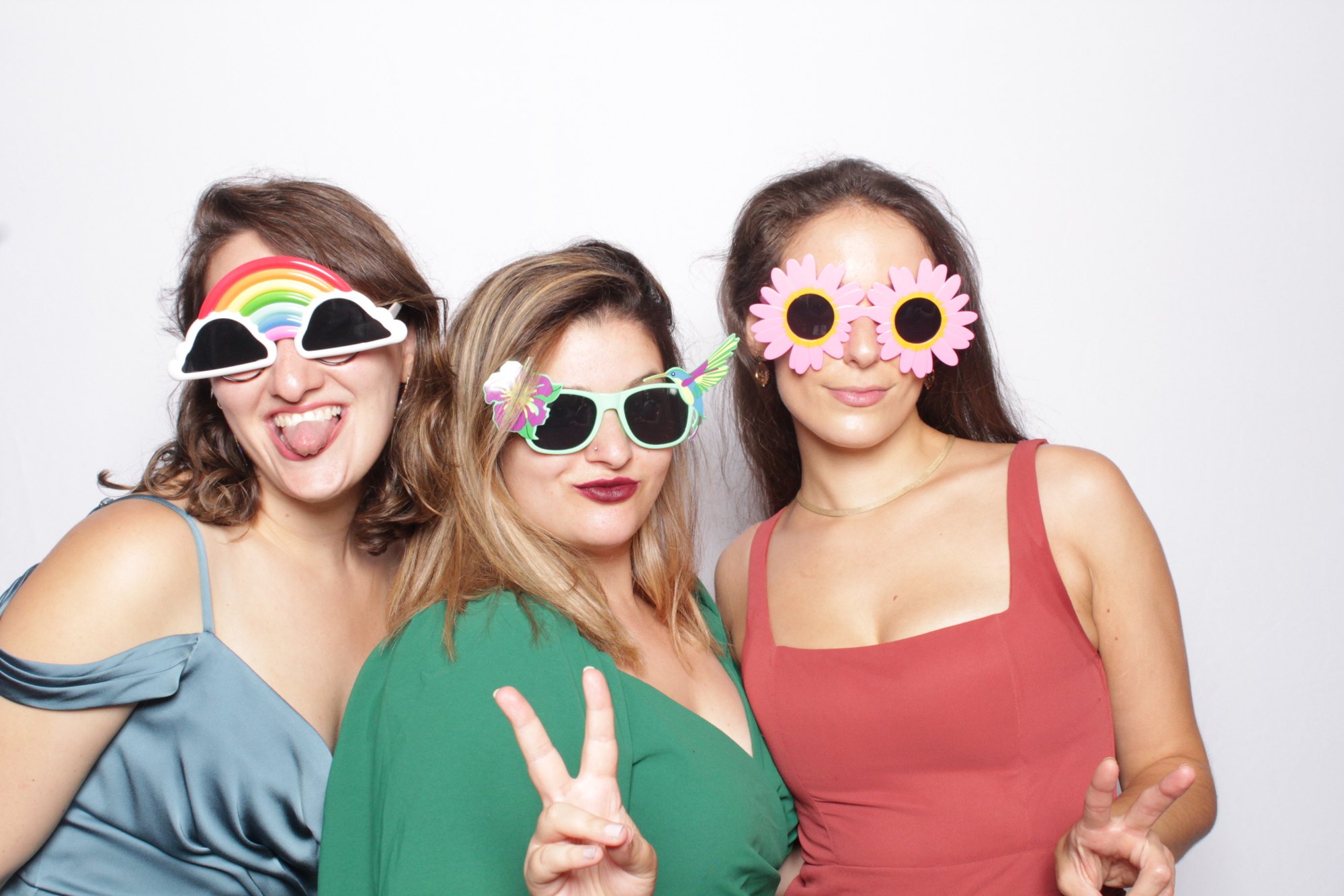 Guests in novelty flower sunglasses posing at the booth