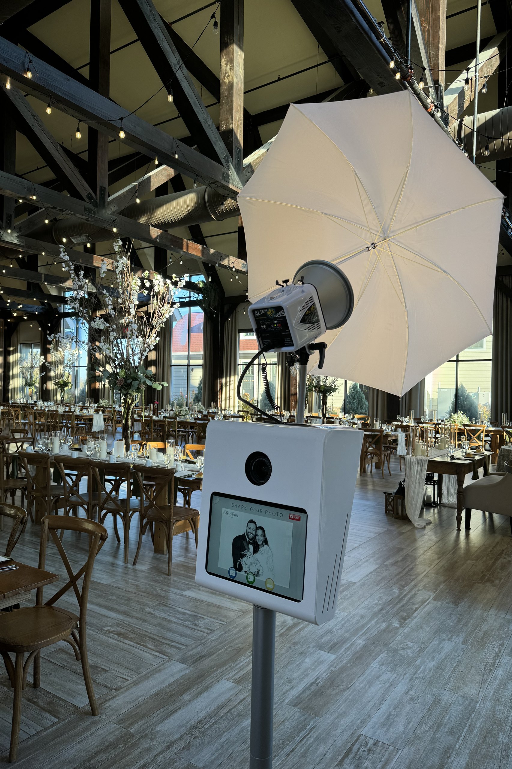 The booth set up under chandeliers at a wedding venue