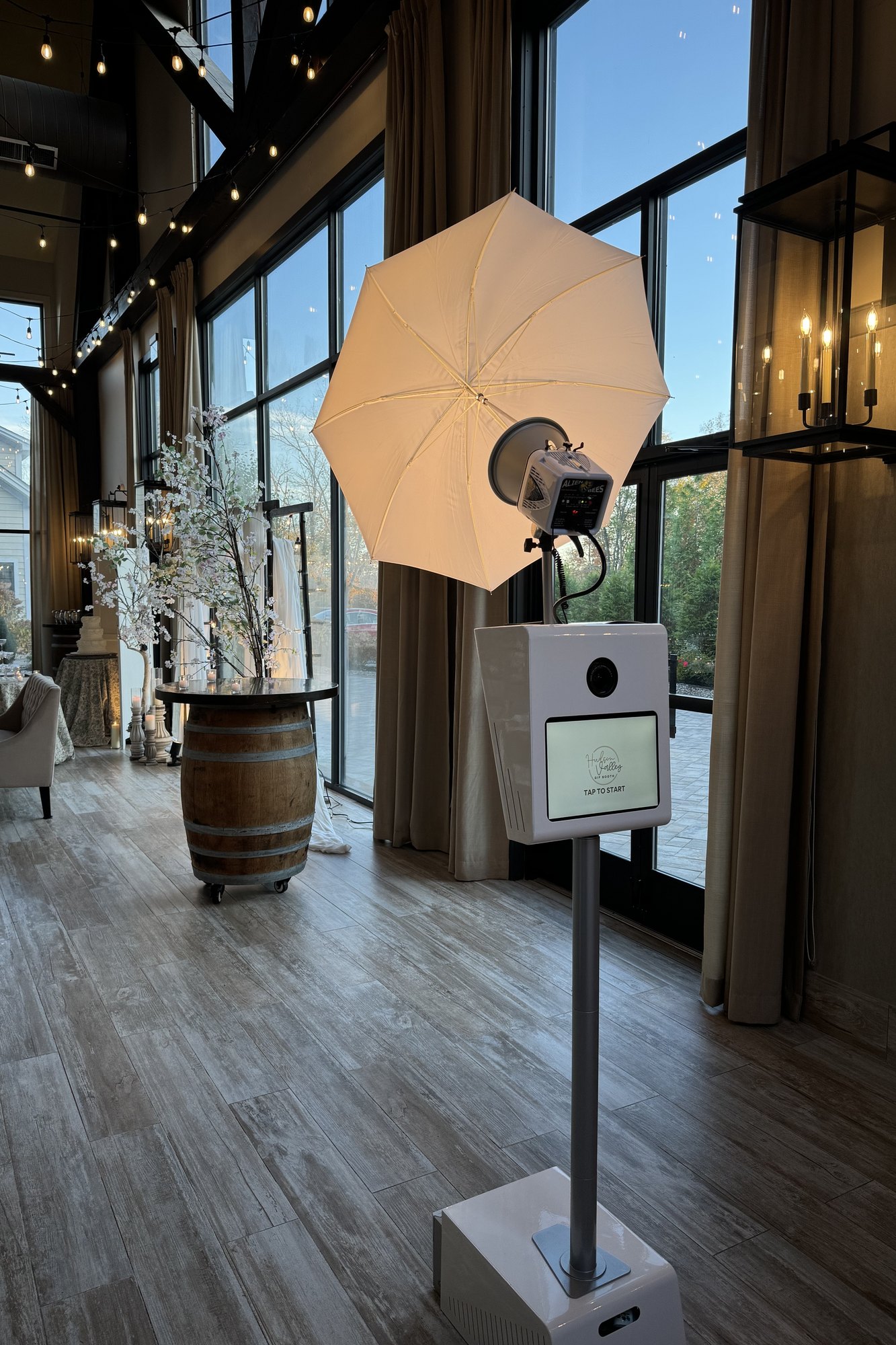 The booth and its umbrella light standing ready in a dressed reception room